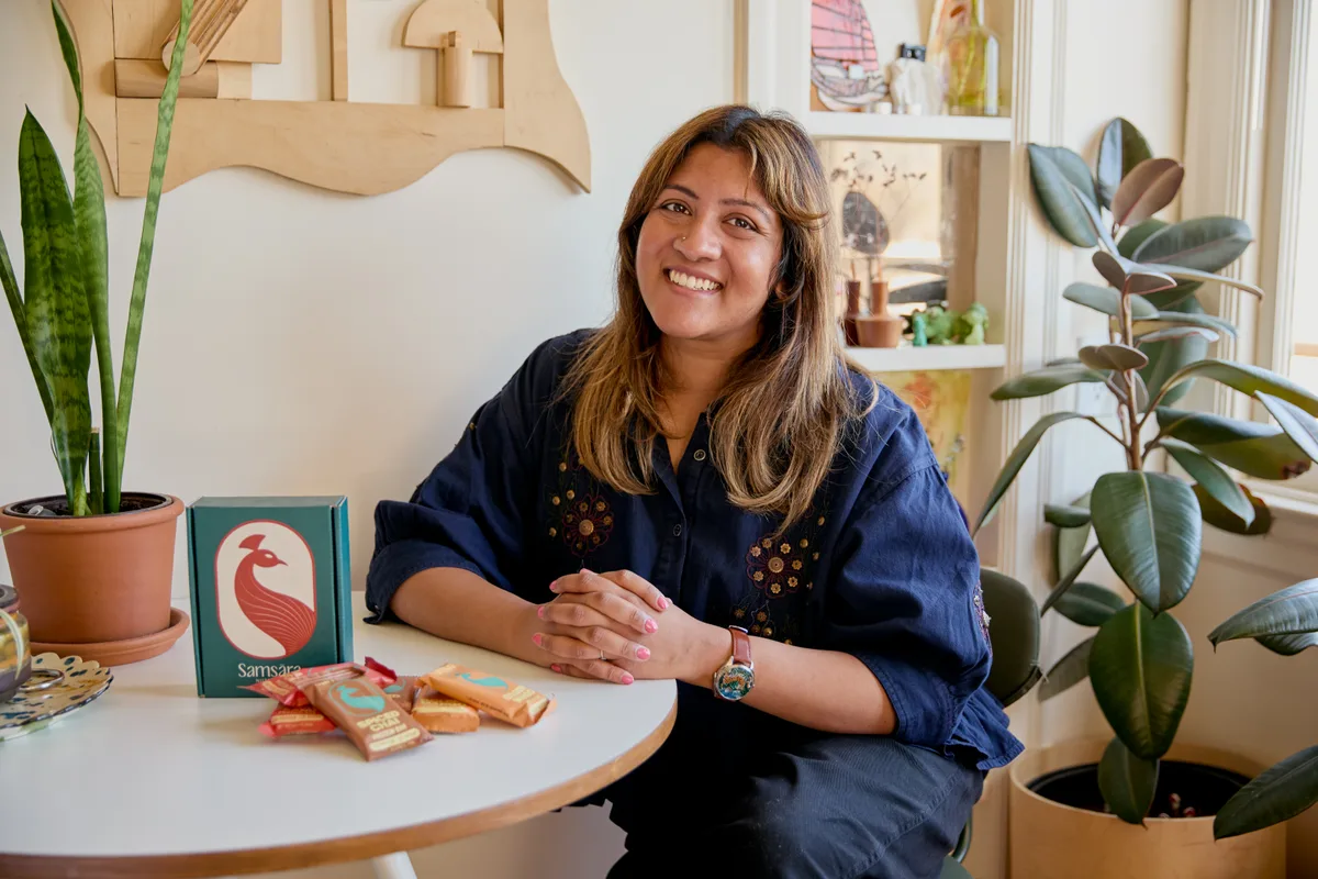 Sravanti, founder of Samsara Nutrition, at her kitchen table with the bars